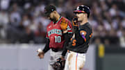 May 13, 2025; San Francisco, California, USA; Arizona Diamondbacks shortstop Jordan Lawlar (10) tosses the ball as San Francisco Giants right fielder Mike Yastrzemski (5) reacts after hitting a double during the fourth inning at Oracle Park. Mandatory Credit: John Hefti-Imagn Images