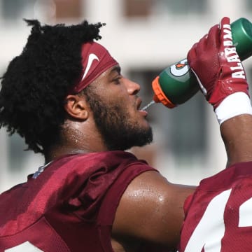 The Crimson Tide works out on the first day of practice for the 2024 season Wednesday, July 31, 2024. Alabama linebacker Keanu Khot (19) grabs a drink of water during a water break.