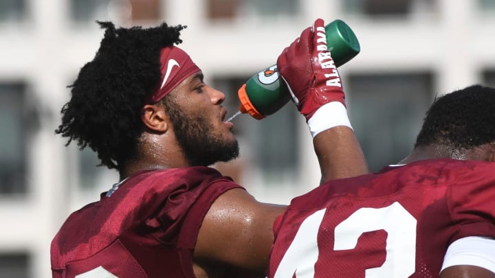 The Crimson Tide works out on the first day of practice for the 2024 season Wednesday, July 31, 2024. Alabama linebacker Keanu Khot (19) grabs a drink of water during a water break.