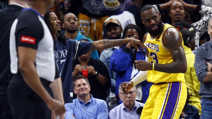 Apr 12, 2024; Memphis, Tennessee, USA; Memphis Grizzlies guard Ja Morant (left) playfully pushes Los Angeles Lakers forward LeBron James (right).