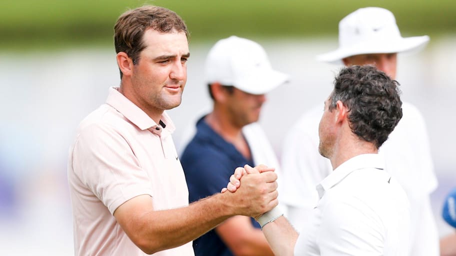 Scottie Scheffler and Rory McIlroy shake hands after finishing their round at the 2023 FedEx St. Jude Championship.