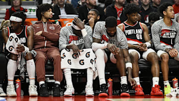Mar 11, 2024; Portland, Oregon, USA; The Portland Trail Blazers bench, from left, guard Malcolm Brogdon (11), guard Shaedon Sharpe (17), center Duop Reath (26), center Deandre Ayton (2), guard Scoot Henderson (00), and guard Anfernee Simons (1) watch the final minutes of a game against the Boston Celtics at Moda Center. Mandatory Credit: Troy Wayrynen-Imagn Images