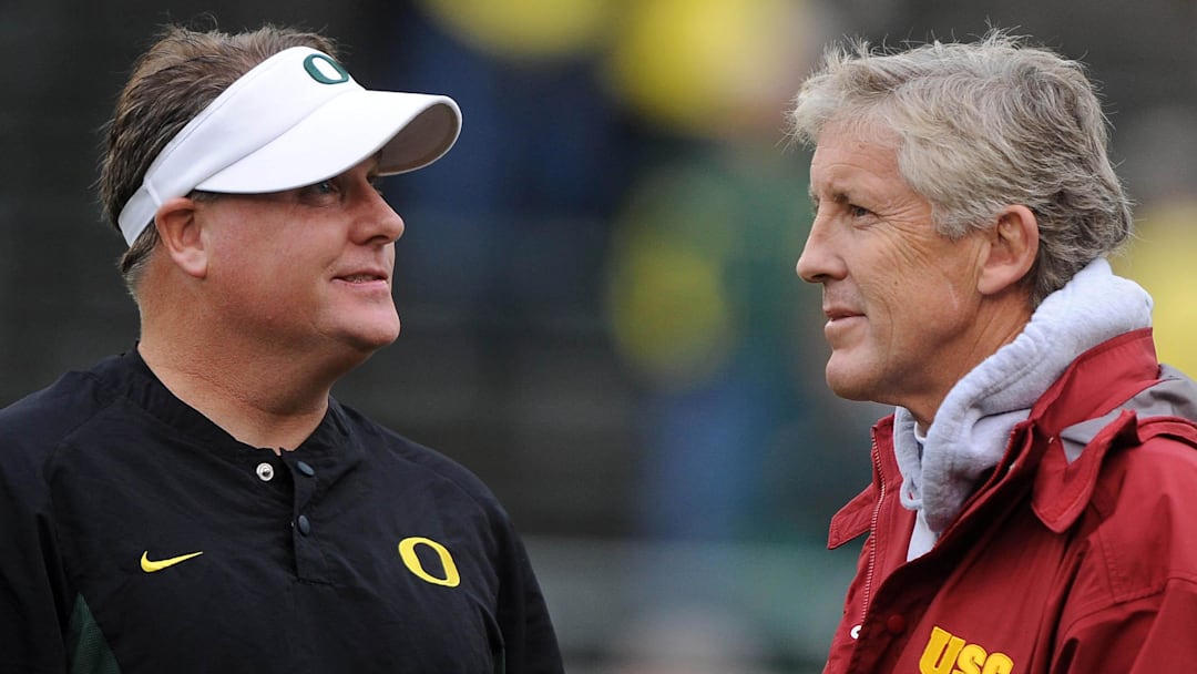 Oct 31, 2009; Eugene, OR, USA; Oregon Ducks coach Chip Kelly (left) and Southern California Trojans coach Pete Carroll (right) before the game at Autzen Stadium. Mandatory Credit: Kirby Lee/Image of Sport-Imagn Images
