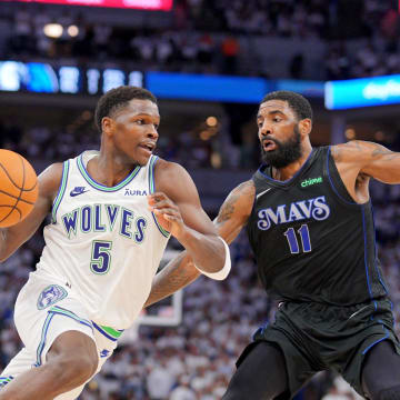 May 24, 2024; Minneapolis, Minnesota, USA; Minnesota Timberwolves guard Anthony Edwards (5) controls the ball against Dallas Mavericks guard Kyrie Irving (11) in the second quarter during game two of the western conference finals for the 2024 NBA playoffs at Target Center. Mandatory Credit: Brad Rempel-USA TODAY Sports