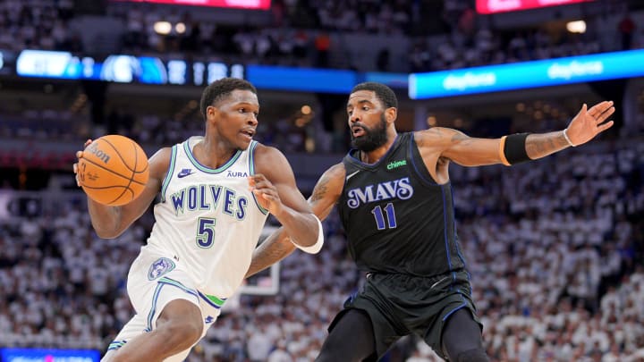 May 24, 2024; Minneapolis, Minnesota, USA; Minnesota Timberwolves guard Anthony Edwards (5) controls the ball against Dallas Mavericks guard Kyrie Irving (11) in the second quarter during game two of the western conference finals for the 2024 NBA playoffs at Target Center. Mandatory Credit: Brad Rempel-USA TODAY Sports