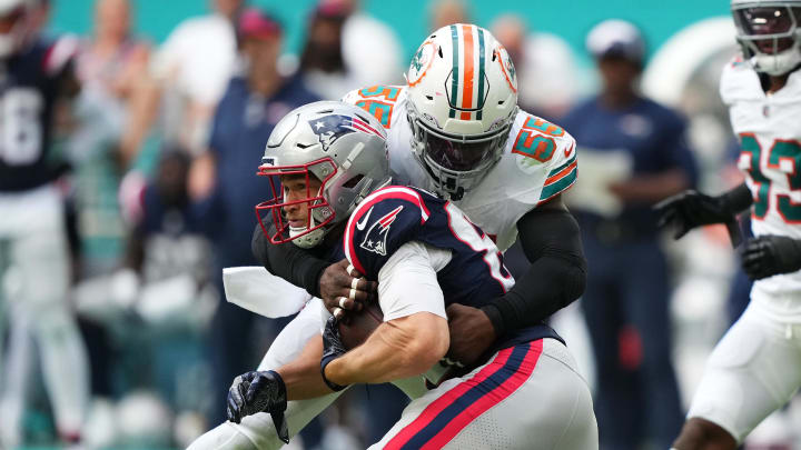 Oct 29, 2023; Miami Gardens, Florida, USA; Miami Dolphins linebacker Jerome Baker (55) tackles New England Patriots tight end Mike Gesicki (88) during the second half at Hard Rock Stadium. Mandatory Credit: Jasen Vinlove-USA TODAY Sports