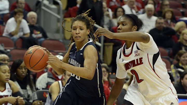 Dec 15, 2014; Louisville, KY, USA; Old Dominion Lady Monarchs forward Jennie Simms (25) dribbles against Louisville Cardinals forward Myisha Hines-Allen (2) during the first half at KFC Yum! Center. Mandatory Credit: Jamie Rhodes-Imagn Images