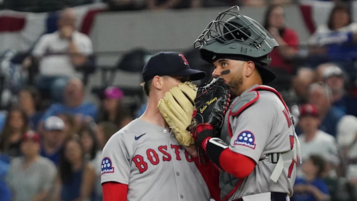 Mar 29, 2025; Arlington, Texas, USA; Boston Red Sox starting pitcher Walker Buehler (0) is visited on the mound by catcher Carlos Narvaez (75) during the first inning against the Texas Rangers at Globe Life Field. Mandatory Credit: Raymond Carlin III-Imagn Images