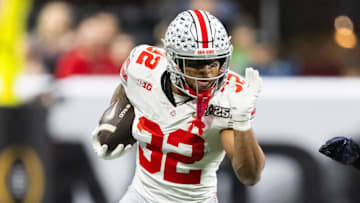 Jan 20, 2025; Atlanta, GA, USA; Ohio State Buckeyes running back TreVeyon Henderson (32) against the Notre Dame Fighting Irish during the CFP National Championship college football game at Mercedes-Benz Stadium. Mandatory Credit: Mark J. Rebilas-Imagn Images