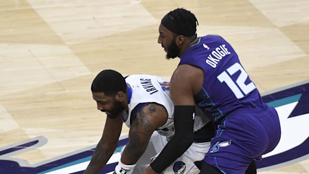 Dallas Mavericks guard Kyrie Irving (11) grabs the ball ahead of Charlotte Hornets 