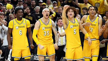 Missouri Tigers players Annor Boateng (6), Jacob Crews (35), T.O. Barrett (5), and Trent Pierce (11) celebrate from the bench in a win against the Kansas Jayhawks.
