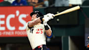 Texas Rangers designated hitter Dylan Moore (25) hits an rbi sacrifice fly during the second inning against the Houston Astros at Globe Life Field. 