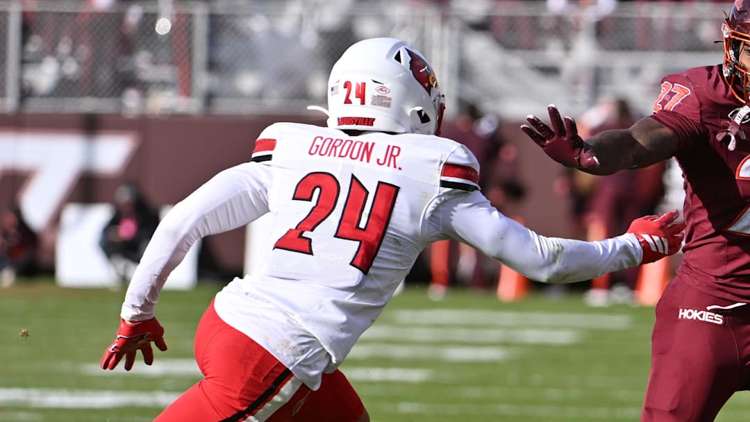 Nov 1, 2025; Blacksburg, Virginia, USA; Virginia Tech Hokies running back Marcellous Hawkins (27) runs the ball as Louisville Cardinals defensive back Corey Gordon (24) defends during the second quarter at Lane Stadium. Mandatory Credit: Brian Bishop-Imagn Images