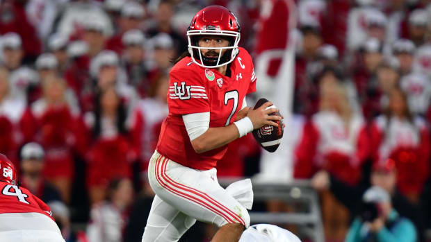 Utah Utes quarterback Cameron Rising escapes the pocket during a college football game in the Big 12.