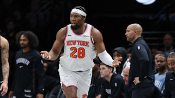 Nov 24, 2025; Brooklyn, New York, USA; New York Knicks forward Guerschon Yabusele (28) reacts in front of Brooklyn Nets guard Tyrese Martin (13) during the second half at Barclays Center. Mandatory Credit: Vincent Carchietta-Imagn Images