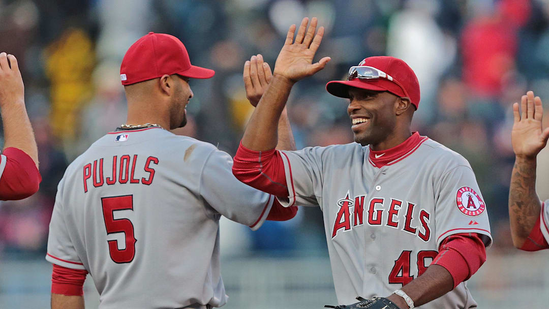 Apr 9, 2012; Minneapolis, MN, USA: Los Angeles Angels right fielder Torii Hunter (48) celebrates with first baseman Albert Pujols (5) after beating the Minnesota Twins at Target Field. The Angels won 5-1. Mandatory Credit: Jesse Johnson-Imagn Images