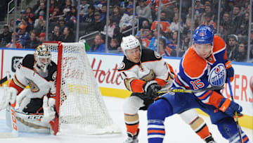 Oct 4, 2016; Edmonton, Alberta, CAN; Anaheim Ducks goalie John Gibson (36) watches Edmonton Oilers center Tyler Pitlik (15) as Ducks defenceman Brandon Montour (71) chases during the second period of a preseason hockey game at Rogers Place. Oilers won the game 2-1. Mandatory Credit: Walter Tychnowicz-Imagn Images