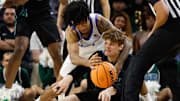 Mar 15, 2025; Fort Worth, TX, USA;  Memphis Tigers guard PJ Haggerty (4) and Tulane Green Wave guard Rowan Brumbaugh (7) battle for possession of the ball during the second half at Dickies Arena