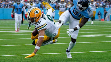 Green Bay Packers wide receiver Christian Watson (9) receives a pass past Tennessee Titans cornerback Roger McCreary (21) during the first quarter at Nissan Stadium in Nashville, Tenn., Sunday, Sept. 22, 2024.