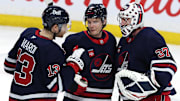 Feb 7, 2025; Winnipeg, Manitoba, CAN; Winnipeg Jets center Gabriel Vilardi (13)m Winnipeg Jets center Vladislav Namestnikov (7) and Winnipeg Jets goaltender Connor Hellebuyck (37) celebrate their victory over the New York Islanders at Canada Life Centre. Mandatory Credit: James Carey Lauder-Imagn Images