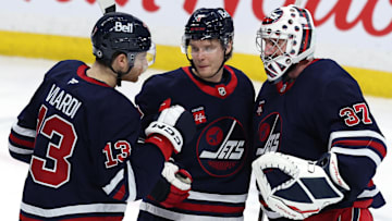 Feb 7, 2025; Winnipeg, Manitoba, CAN; Winnipeg Jets center Gabriel Vilardi (13)m Winnipeg Jets center Vladislav Namestnikov (7) and Winnipeg Jets goaltender Connor Hellebuyck (37) celebrate their victory over the New York Islanders at Canada Life Centre. Mandatory Credit: James Carey Lauder-Imagn Images