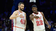 Feb 27, 2023; Philadelphia, Pennsylvania, USA; Miami Heat forward Jimmy Butler (22) talks with forward Kevin Love (42) during a break in action in the second quarter against the Philadelphia 76ers at Wells Fargo Center. Mandatory Credit: Bill Streicher-Imagn Images