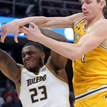 Kent State Golden Flashes forward Magnus Entenmann (14) and Toledo Rockets guard Tyler Cochran (23) fight for a rebound during the second half of an NCAA college basketball game in the quarterfinals of the Mid-American Conference Tournament at Rocket Mortgage FieldHouse, Thursday, March 14, 2024, in Cleveland, Ohio.