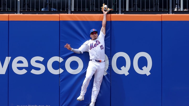 Jul 31, 2024; New York City, New York, USA; New York Mets center fielder Tyrone Taylor leaps at the wall.