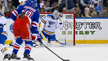 Nov 24, 2025; New York, New York, USA;  St. Louis Blues goaltender Joel Hofer (30) makes a glove save against the New York Rangers during the first period at Madison Square Garden. Mandatory Credit: Dennis Schneidler-Imagn Images