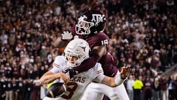 Nov 30, 2024; College Station, Texas, USA; Texas Longhorns quarterback Quinn Ewers (3) is sacked by Texas A&M Aggies defensive lineman Cashius Howell (18) in the third quarter of the Lone Star Showdown at Kyle Field. Mandatory Credit: Sara Diggins/USA TODAY Network via Imagn Images