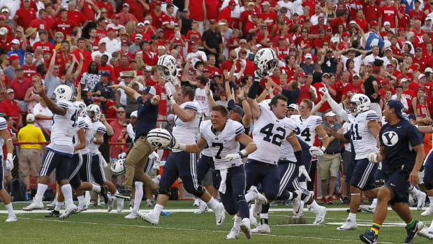 Brigham Young Cougars players run onto the field after defeating the Nebraska Cornhuskers with a last second touchdown.