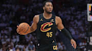 Apr 26, 2025; Miami, Florida, USA; Cleveland Cavaliers guard Donovan Mitchell (45) dribbles the basketball as Miami Heat forward Andrew Wiggins (22) defends in the first quarter during game three for the first round of the 2025 NBA Playoffs at Kaseya Center. Mandatory Credit: Sam Navarro-Imagn Images
