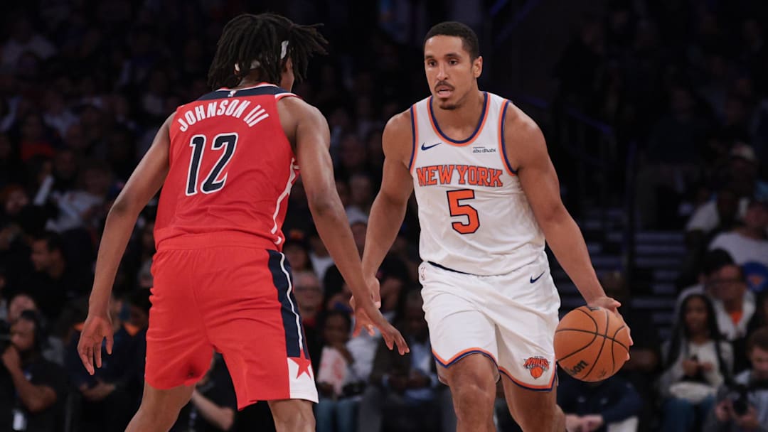 Oct 13, 2025; New York, New York, USA; New York Knicks guard Malcolm Brogdon (5) dribbles against Washington Wizards guard Tre Johnson (12)during the first half at Madison Square Garden. Mandatory Credit: Vincent Carchietta-Imagn Images