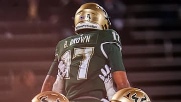 Oct 21, 2023; East Hartford, Connecticut, USA; Quarterback Byrum Brown earned a ride on his teammates' shoulders after running for a touchdown last year against UConn. But things could go better for the Bulls this year if Brown runs fewer times. David Butler II-USA TODAY Sports