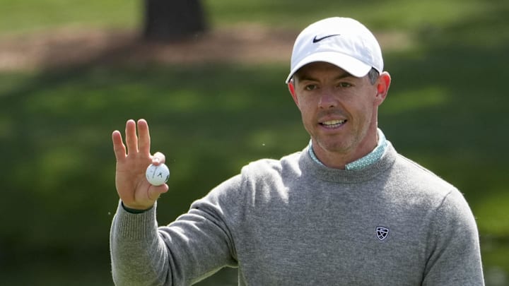 Rory McIlroy holds up his ball on the fourth green during the Par 3 Contest at the Masters Tournament