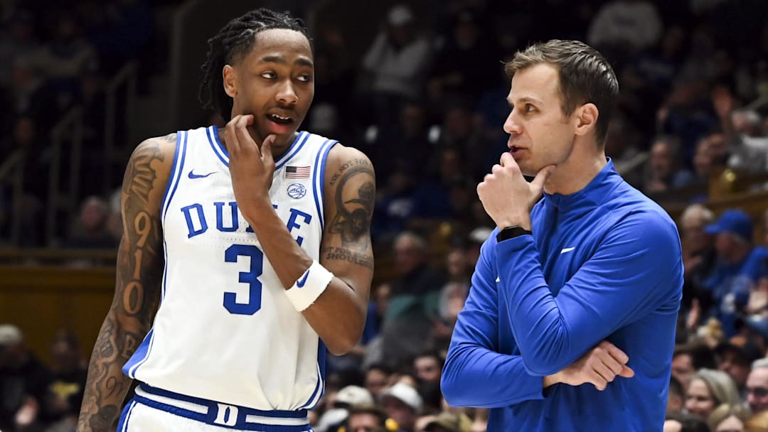 Duke Blue Devils head coach Jon Scheyer (right) talks to forward Isaiah Evans (3)