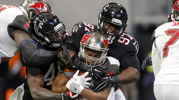 New Bears defensive tackle Grady Jarrett wraps up former Tampa Bay running back Doug Martin earlier in his Falcons career.