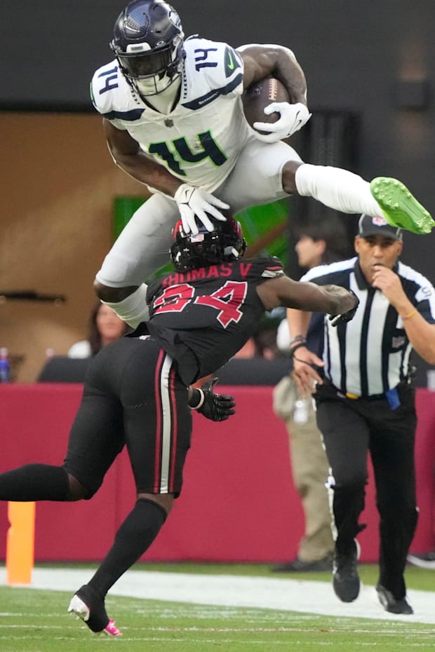 Seattle Seahawks wide receiver DK Metcalf (14) jumps over Arizona Cardinals cornerback Starling Thomas V (24).