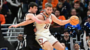 Mar 21, 2025; Milwaukee, WI, USA: Illinois Fighting Illini center Tomislav Ivisic (13) drives to the hoop past Xavier Musketeers forward Zach Freemantle (32) during the first half at Fiserv Forum. Mandatory Credit: Benny Sieu-Imagn Images