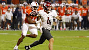 Oct 18, 2025; Charlottesville, Virginia, USA; Washington State Cougars quarterback Zevi Eckhaus (4) throws an interception while scrambling from Virginia Cavaliers defensive end Cazeem Moore (6) in the fourth quarter at Scott Stadium. Mandatory Credit: Geoff Burke-Imagn Images
