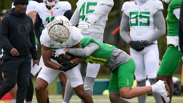 Oregon defensive back Kodi DeCambra tackles running back Ellis Bynum during a practice Tuesday, April 4, 2023.Football Oreg
