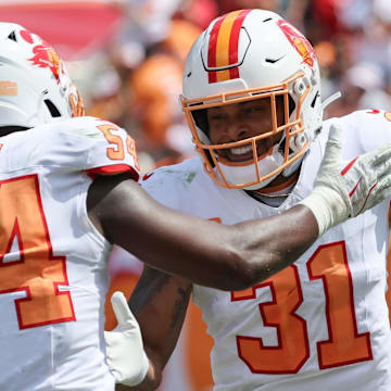 Sep 21, 2025; Tampa, Florida, USA; Tampa Bay Buccaneers safety Antoine Winfield Jr. (31) is congratulated by outside linebacker Lavonte David (54) after he forces a fumble against the Tampa Bay Buccaneer against the New York Jets during the second quarter at Raymond James Stadium. Mandatory Credit: Kim Klement Neitzel-Imagn Images