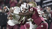 Nov 15, 2025; Tallahassee, Fla.; Virginia Tech quarterback Kyron Drones (1) has the ball knocked away by Florida State defensive lineman Mandrell Desir (93).