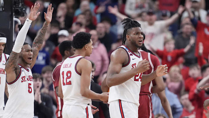 Mar 22, 2025; Providence, RI, USA; St. John's basketball guard Deivon Smith (5), forward Zuby Ejiofor (24), and forward RJ Luis (12) react to a play during the second half of a second round men’s NCAA Tournament game against the Arkansas Razorbacks at Amica Mutual Pavilion.