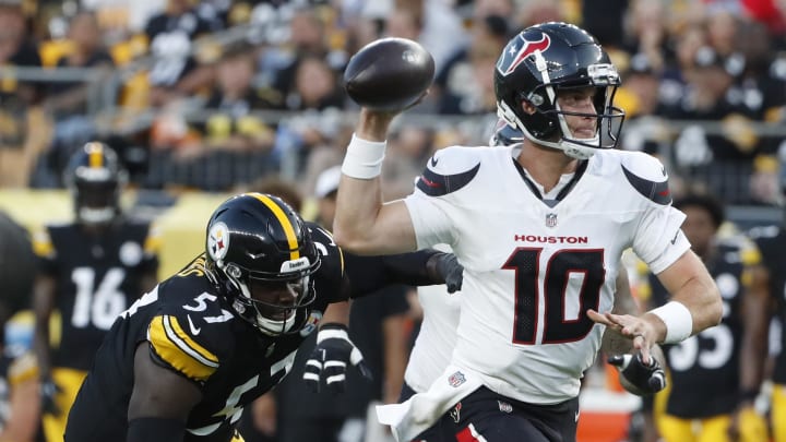 Aug 9, 2024; Pittsburgh, Pennsylvania, USA;  Houston Texans quarterback Davis Mills (10) scrambles with the ball past Pittsburgh Steelers defensive tackle Montravius Adams (57) during the second quarter at Acrisure Stadium.  Houston won 20-12. Mandatory Credit: Charles LeClaire-USA TODAY Sports