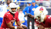 Arizona Cardinals quarterback Jacoby Brissett (7) hands off the ball against the Los Angeles Rams in the first half at State Farm Stadium on Dec 7, 2025, in Glendale, Ariz.