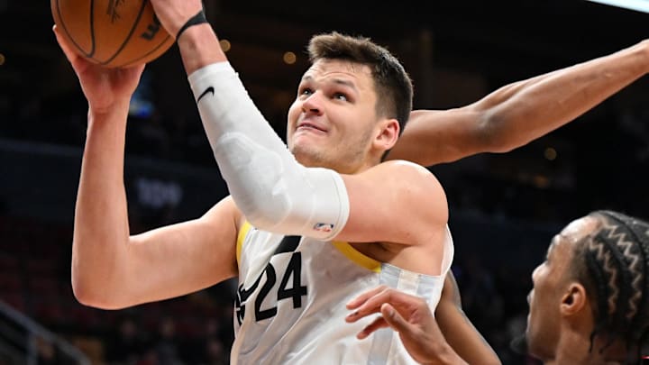 Mar 7, 2025; Toronto, Ontario, CAN;  Utah Jazz center Walker Kessler (24) goes in for a layup over Toronto Raptors guard AJ Lawson (0) in the second half at Scotiabank Arena. Mandatory Credit: Dan Hamilton-Imagn Images