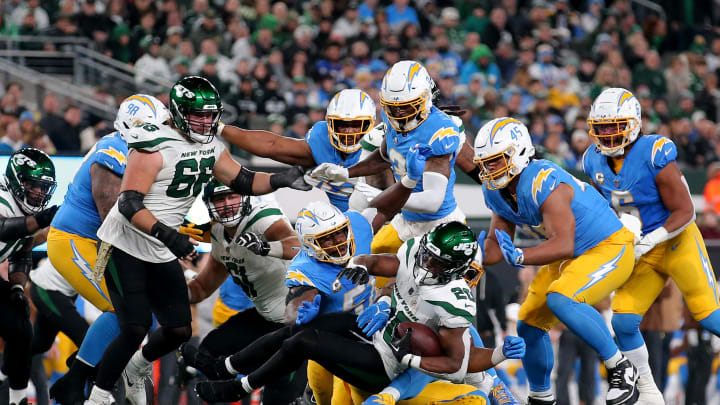 Nov 6, 2023; East Rutherford, New Jersey, USA; New York Jets running back Breece Hall (20) is tackled by Los Angeles Chargers defensive tackle Sebastian Joseph-Day (51) during the second quarter at MetLife Stadium. Mandatory Credit: Brad Penner-USA TODAY Sports