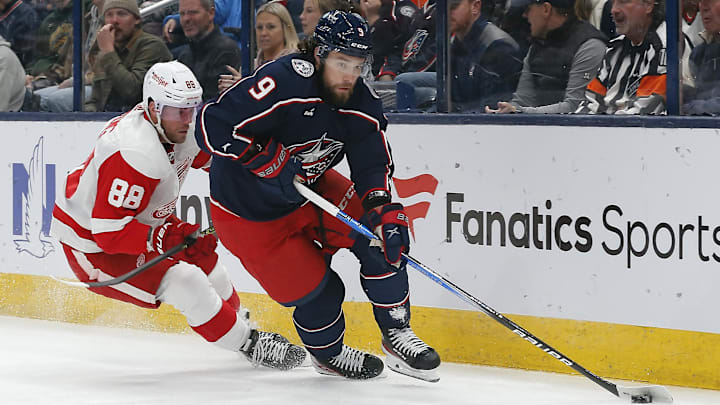 Oct 16, 2023; Columbus, Ohio, USA; Columbus Blue Jackets defenseman Ivan Provorov (9) carries the puck away from Detroit Red Wings right wing Daniel Sprong (88) during the first period at Nationwide Arena. Mandatory Credit: Russell LaBounty-Imagn Images