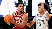 Arkansas guard D.J. Wagner (21) bolts past Vanderbilt guard Tyler Tanner (3) during the second half at Memorial Gym in Nashville, Tenn.
